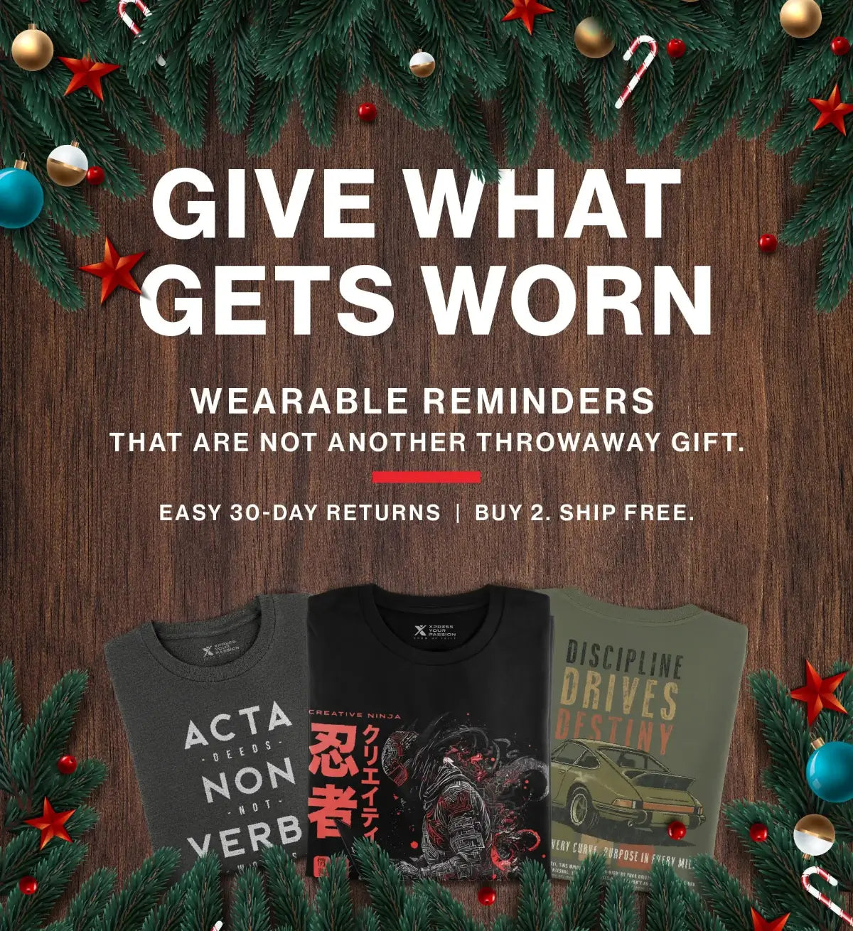 Three t-shirts with motivational phrases on a wooden background with Christmas decorations.